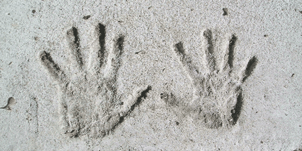 hands in cement impression